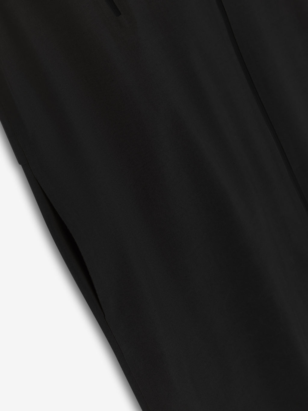 close-up detail of black stretch wool blend fabric with water-resistant finish on technical trench jacket