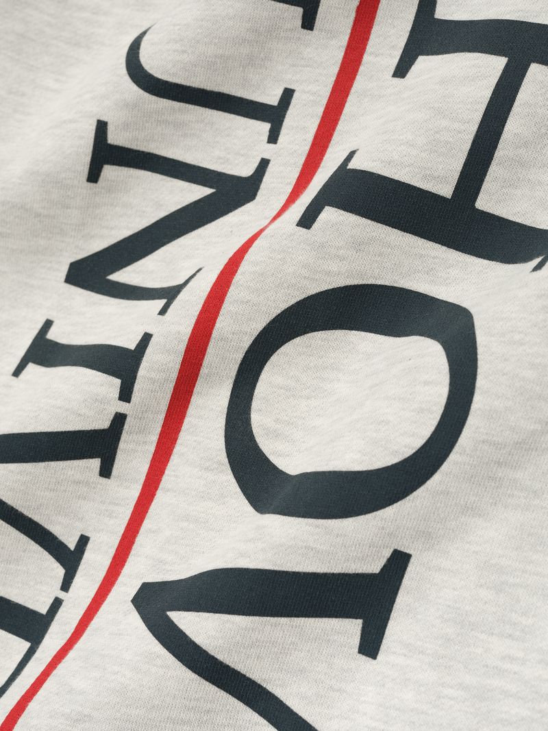 Close-up of cream-colored Howard University Lounge Sweatpant showing bold navy text and a red vertical stripe, file deOmsM-w.jpg