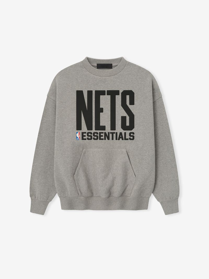 Grey crewneck with large black NETS lettering, ESSENTIALS text, NBA logo above front kangaroo pocket and ribbed cuffs