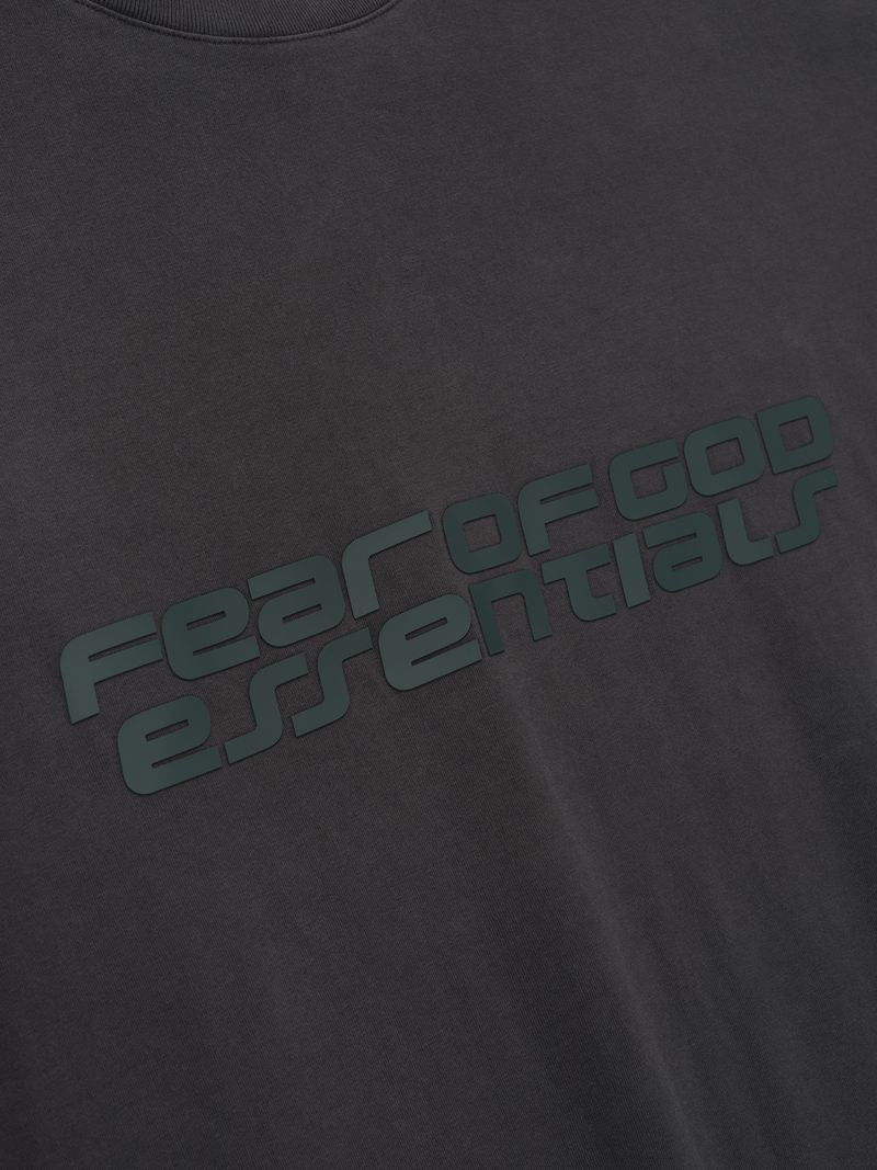 Black t-shirt with 'Fear of God essentials' text in green on a dark background